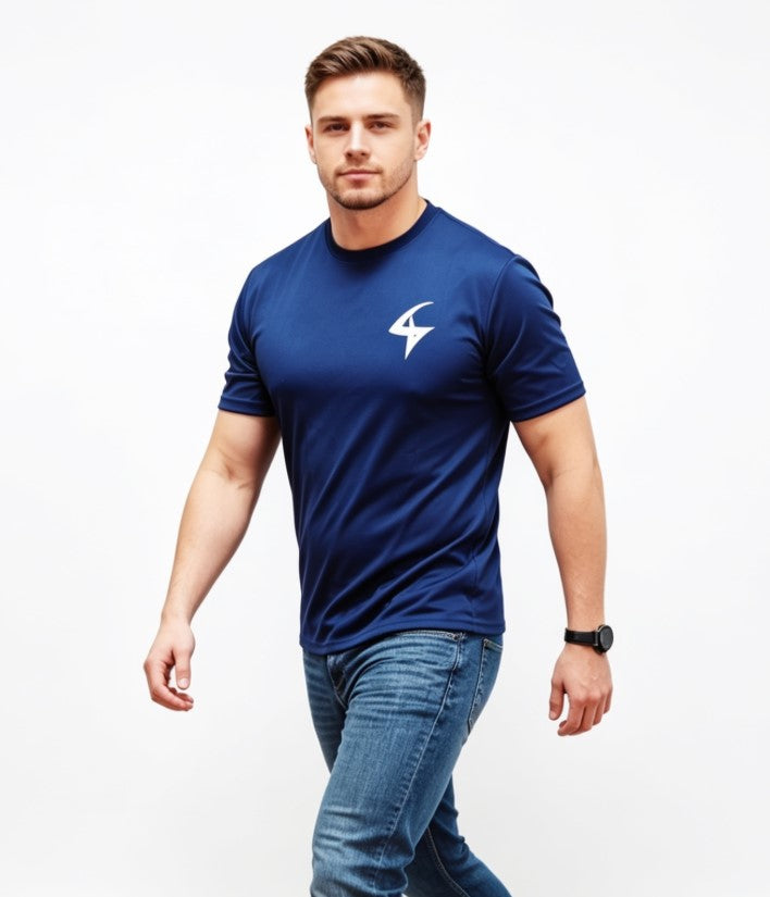 A man wearing a navy blue athletic t-shirt with a white lightning bolt logo on the left chest, paired with blue jeans, photographed against a solid white background.