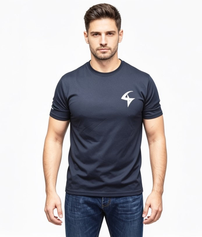 A man wearing a dark navy blue short-sleeve crewneck t-shirt with a white stylized logo on the left chest, paired with blue jeans, against a plain white background.