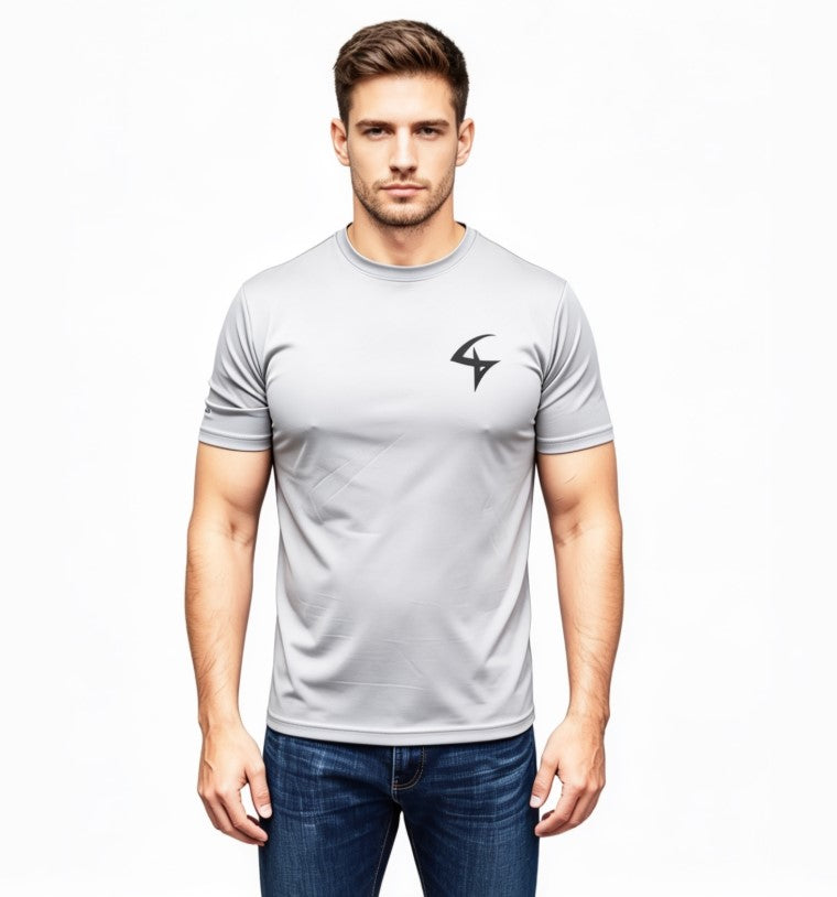 A man wearing a light gray short-sleeve athletic t-shirt with a black stylized logo on the left chest, paired with blue jeans, against a plain white background.